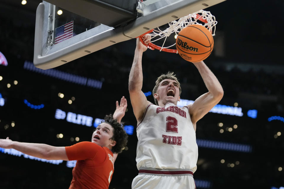 Alabama forward Grant Nelson (2) dunks past Clemson forward Ian Schieffelin during the second half of an Elite 8 college basketball game in the NCAA tournament Saturday, March 30, 2024, in Los Angeles. (AP Photo/Ashley Landis)