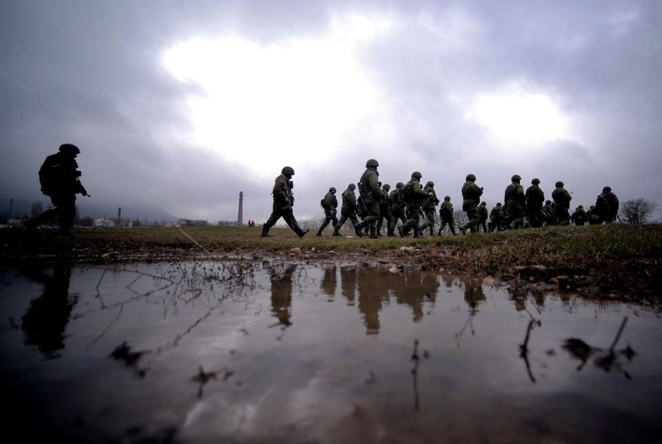 Russian soldiers patrol the area surrounding the Ukrainian military unit in Perevalnoye, outside Simferopol, Crimea, on March 20, 2014. (Filippo Monteforte/AFP via Getty Images)