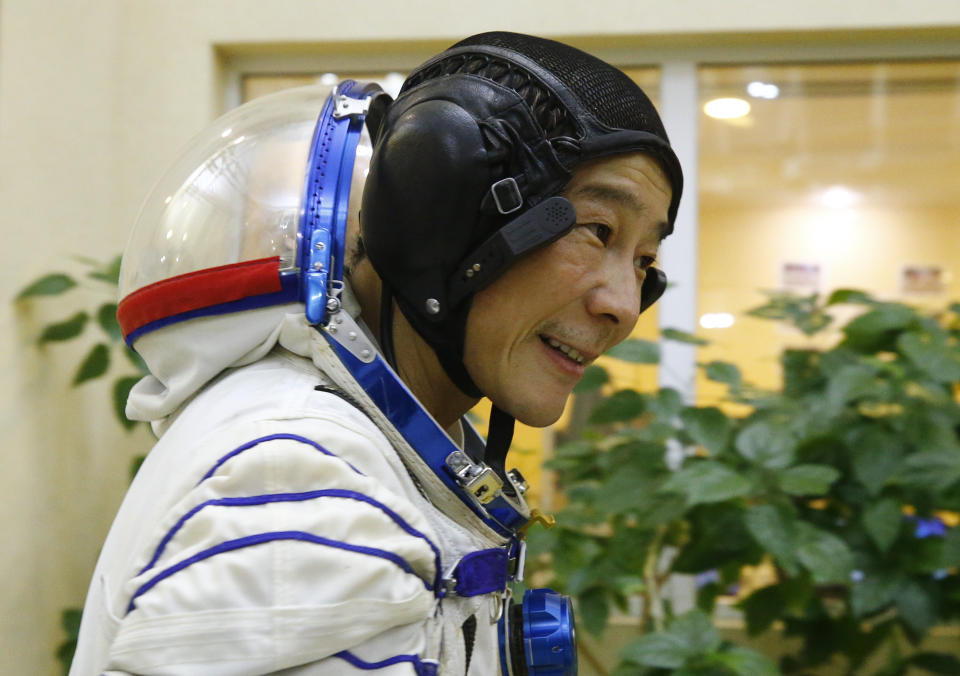 Space flight participant Yusaku Maezawa attends a training session ahead of the expedition to the International Space Station at the Gagarin Cosmonauts' Training Center in Star City outside Moscow, Russia, Thursday, Oct. 14, 2021. A Japanese fashion tycoon who's booked a SpaceX ride to the moon is going to try out the International Space Station first. Yusaku Maezawa announced that he's bought two seats on a Russian Soyuz capsule. He'll blast off in December on the 12-day mission with his production assistant and a professional cosmonaut. (Shamil Zhumatov/Pool Photo via AP)