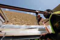 A large wooden segment of the second Khufu boat is lifted from the ground where it was discovered before being transfered to a lab, in Giza, Egypt, March 29, 2017. REUTERS/Mohamed Abd El Ghany