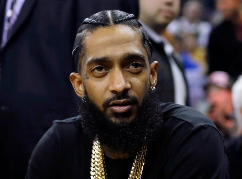 Rapper Nipsey Hussle attends an NBA basketball game between the Golden State Warriors and the Milwaukee Bucks in Oakland, Calif., March 29, 2018. (AP Photo/Marcio Jose Sanchez, File)