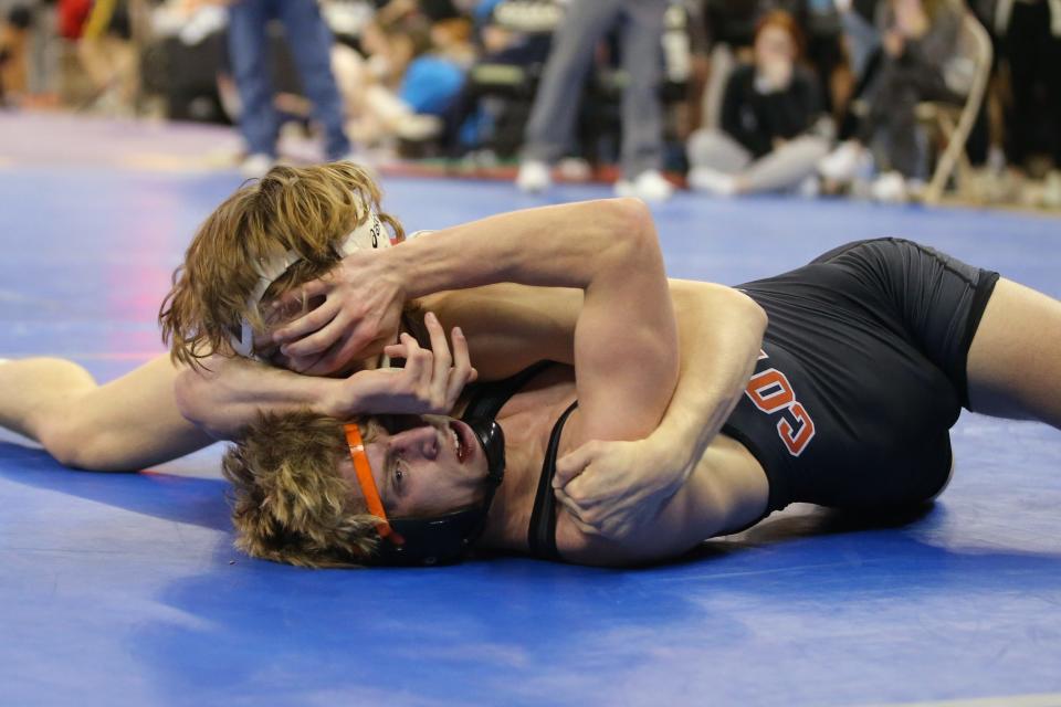 Carl Albert's Kasen Miller, top, wrestles Coweta's Brock Roberts in a Class 5A 138-pound semifinal match at the state tournament on Feb. 24 at State Fair Arena.