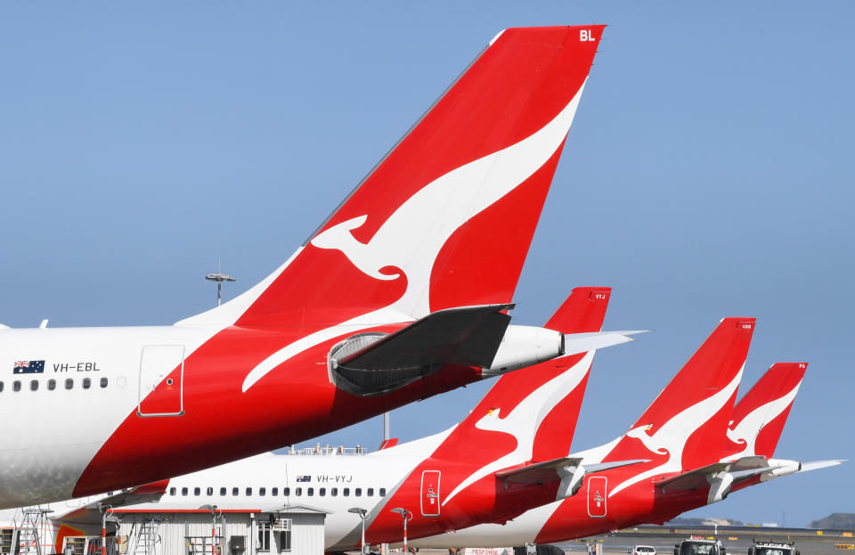 SYDNEY, AUSTRALIA - AUGUST 18: The tail fins of Qantas aircraft parked at Sydney&#39;s Kingsford Smith International Airport on August 18, 2021 in Sydney, Australia. Qantas Group has announced COVID-19 vaccinations will be mandatory for all 22,000 staff members. Frontline employees &#x002014; including cabin crew, pilots and airport workers &#x002014; will need to be fully vaccinated by November 15 and the remainder of employees by March 31. There will be exemptions for those who are unable to be vaccinated for documented medical reasons, which is expected to be very rare. (Photo by James D. Morgan/Getty Images)