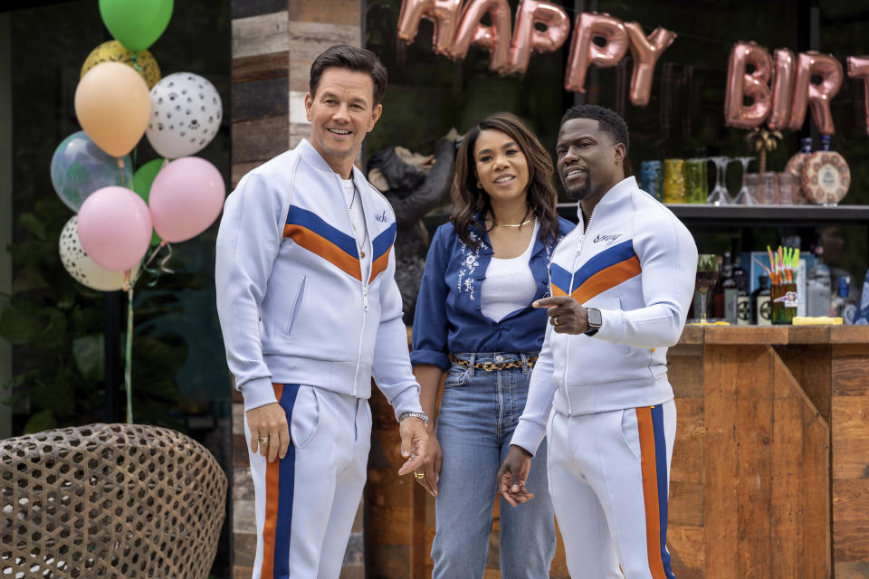 This image released by Netflix shows Mark Wahlberg, from left, Regina Hall and Kevin Hart in "Me Time." (Saeed Adyani/Netflix via AP)