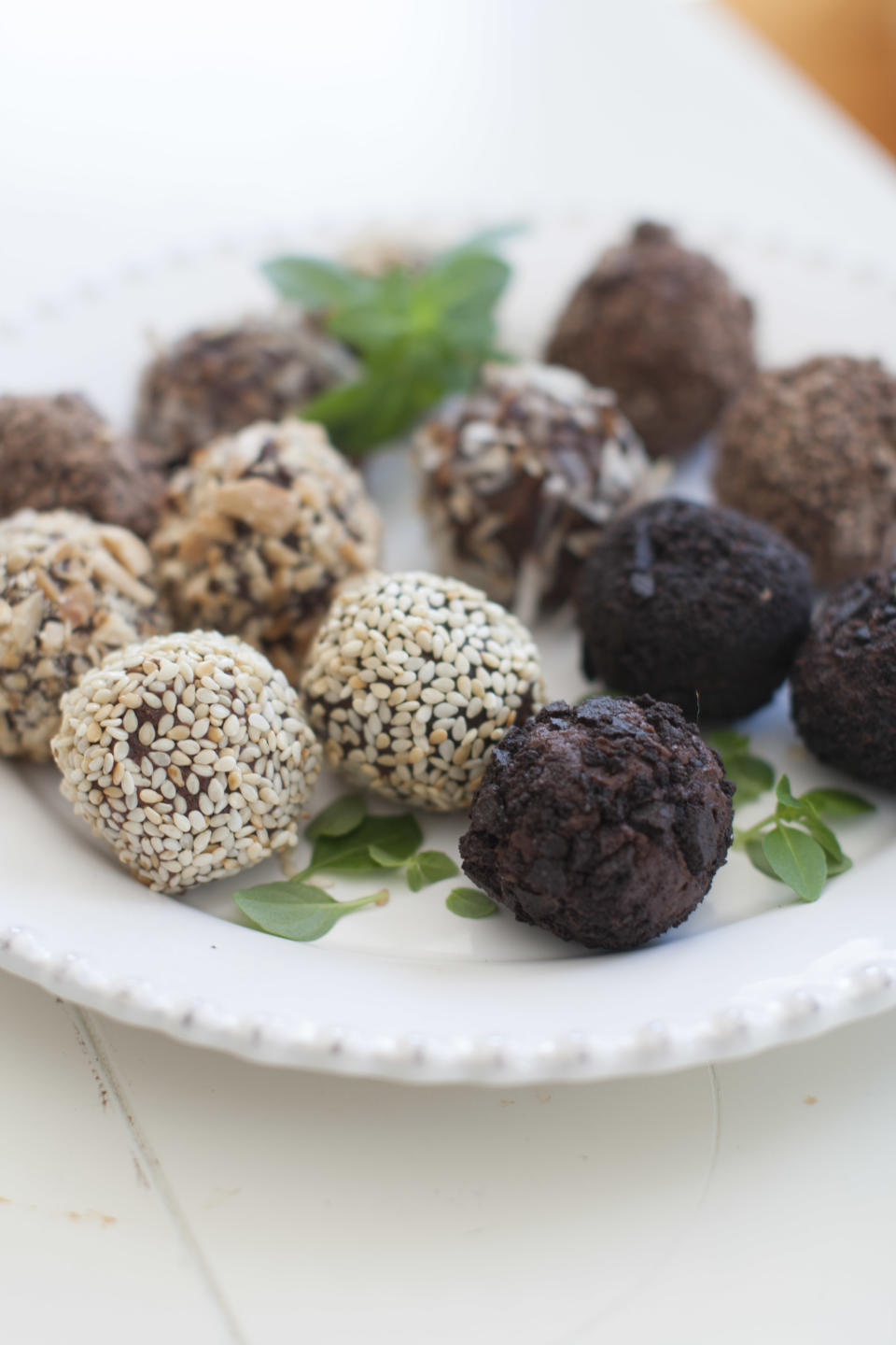 This March 24, 2014 photo shows a variety of basil tea truffles coated with toasted coconut, toasted sesame seeds, chopped marcona almonds and chocolate wafer cookies, in Concord, N.H. (AP Photo/Matthew Mead)