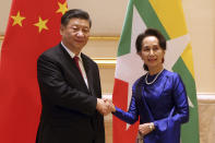 Myanmar's leader Aung San Suu Kyi, right, shakes hands with Chinese President Xi Jinping during their meeting at the Presidential Palace in Naypyitaw, Myanmar, Friday, Jan. 17, 2020. (AP Photo/Aung Shine Oo)