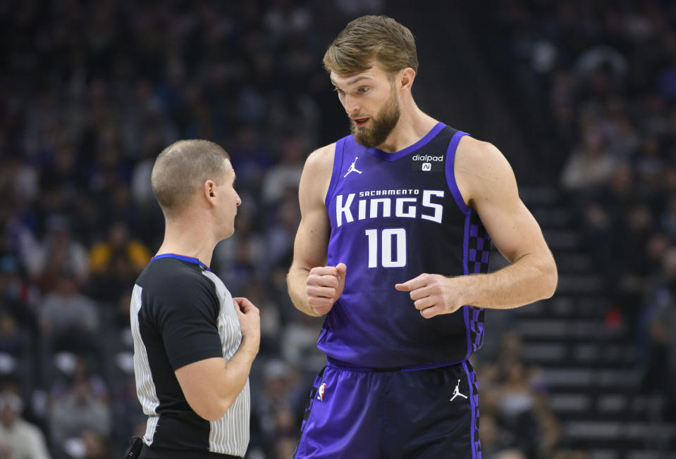 Sacramento Kings forward Domantas Sabonis (10) discusses an official's call with referee Tyler Ford during the first quarter of an NBA basketball game against the Charlotte Hornets in Sacramento, Calif., Tuesday, Jan. 2, 2024. (AP Photo/Randall Benton)