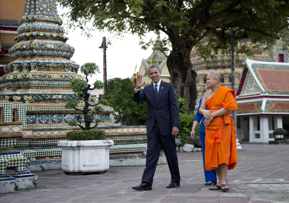 U.S. President Barack Obama, left, and U.S. Secretary of State Hillary Rodham Clinton, rear, tour the Wat Pho Royal Monastery with Chaokun Suthee Thammanuwat, Dean, Faculty of Buddhism Assistant to the Abbot of Wat Phra Chetuphon, in Bangkok, Thailand, Sunday, Nov. 18, 2012. (AP Photo/Carolyn Kaster)