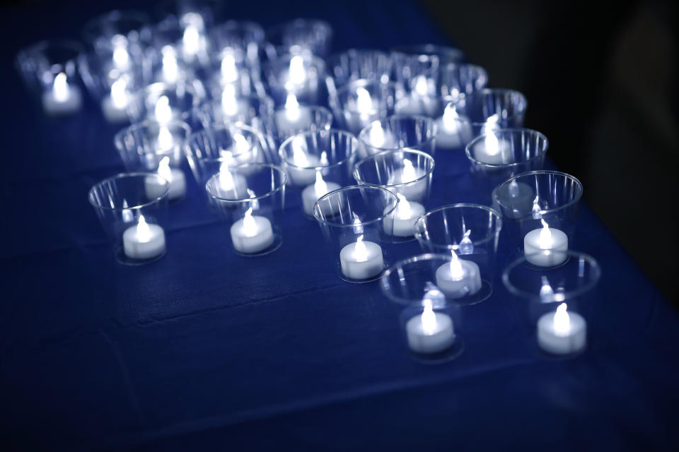 FILE - Tea lights sit illuminated during a vigil at the memorial for the victims of the massacre at Columbine High School nearly 20 years ago Friday, April 19, 2019, in Littleton, Colo. (AP Photo/David Zalubowski, File)