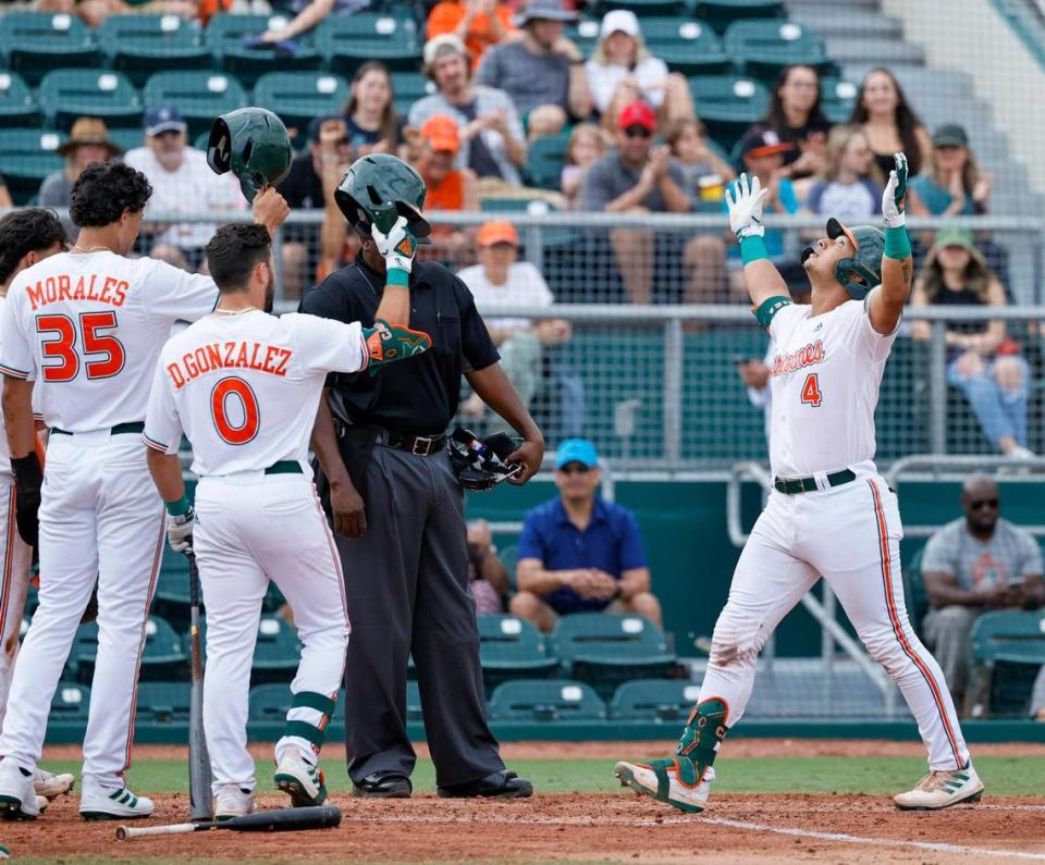 Miami Hurricanes catcher Maxwell Romero Jr. (4) reacts after hitting a three run home run during the third inning of an NCAA baseball game against the Towson Tigers in Alex Rodriguez Park at Mark Light Field on Sunday, February 20, 2022 in Coral Gables.