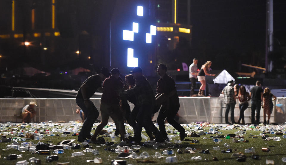 <p>People carry a person at the Route 91 Harvest country music festival after apparent gun fire was heard on Oct. 1, 2017 in Las Vegas, Nevada. There are reports of an active shooter around the Mandalay Bay Resort and Casino. (Photo: David Becker/Getty Images) </p>