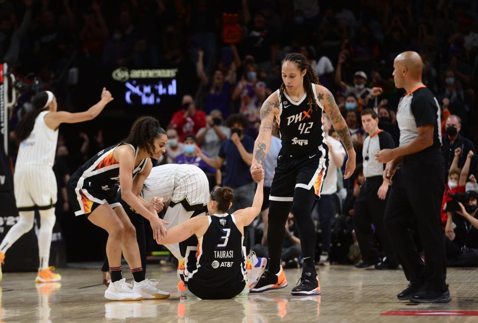 Oct 13, 2021; Phoenix, Arizona, USA; Phoenix Mercury guard Diana Taurasi (3) is helped up by guard Skylar Diggins-Smith (4) and center Brittney Griner (42) after an and one basket against the Chicago Sky during overtime of game two of the 2021 WNBA Finals at Footprint Center. Mandatory Credit: Joe Camporeale-USA TODAY Sports