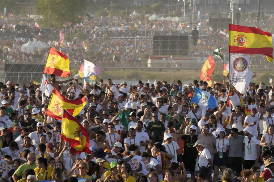 Pilgrims and faithful gather as they wait for a vigil with Pope Francis ahead of the 37th World Youth Day flock to the Parque Tejo in Lisbon, Saturday, Aug. 5, 2023. On Sunday morning, the last day of his five-day trip to Portugal, Francis is to preside over a final, outdoor Mass on World Youth Day – when temperatures in Lisbon are expected to top 40 degrees C (104F) – before returning to the Vatican. (AP Photo/Armando Franca)