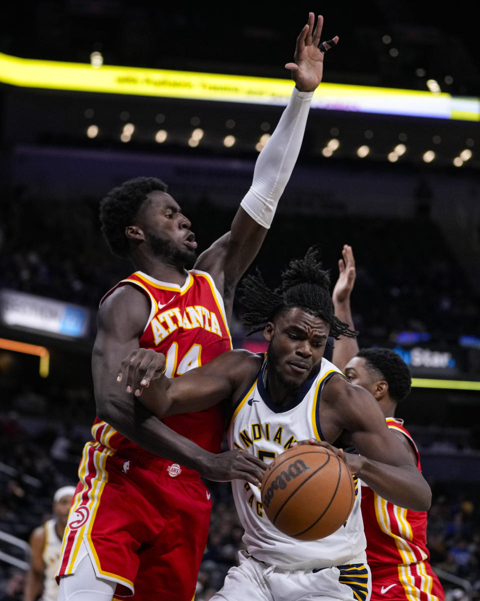 Atlanta Hawks forward AJ Griffin (14) stops Indiana Pacers forward Jarace Walker (5) as he drives during the second half of an NBA preseason basketball game in Indianapolis, Monday, Oct. 16, 2023. Pacers defeated the Hawks 116-112. (AP Photo/Michael Conroy)