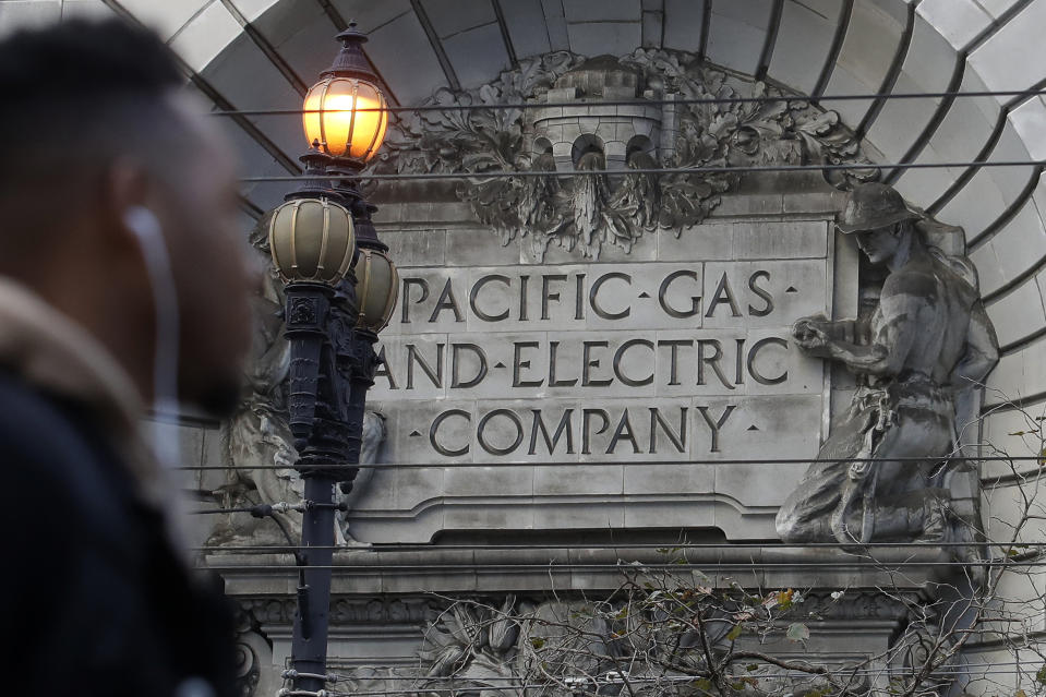 FILE - In this Dec. 16, 2019, file photo, a sign to a Pacific Gas & Electric building is shown in San Francisco. California power regulators are poised to reprimand PG&E for continuing to neglect its electrical grid that has ignited a series of deadly wildfires in Northern California and could order the utility to do be more vigilant in the upcoming months of hot, windy weather. The anticipated rebuke from the California Public Utilities Commission Thursday, April 15, 2021, would serve as official notice to PG&E that it hasn't been doing enough to reduce the risks posed by a combination of crumbling equipment and overgrown trees susceptible to touching or toppling into nearby power lines. (AP Photo/Jeff Chiu, File)