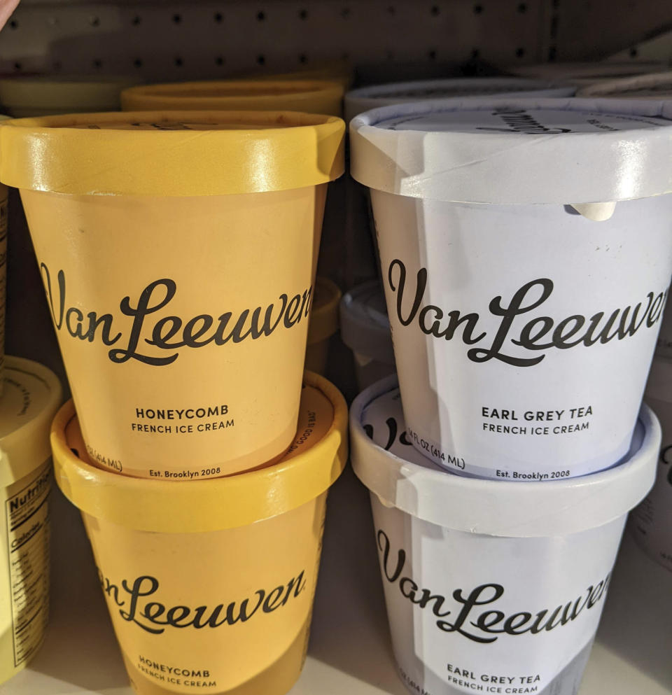 This image provided by Kim Cook shows tubs of Van Leeuwen ice cream on a supermarket freezer shelf. Unusual varieties like honeycomb and tea are part of a growing trend that's taking the beloved treat beyond traditional flavors. (Kim Cook via AP)