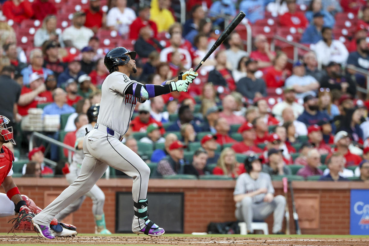 Arizona Diamondbacks' Ketel Marte hits a sacrifice fly during the second inning of a baseball game against the St. Louis Cardinals, Monday, April 22, 2024, in St. Louis. (AP Photo/Scott Kane)