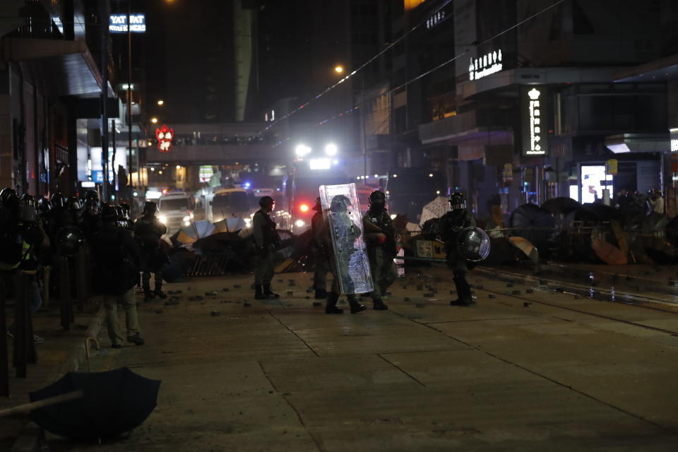 Police arrive to remove barricades set up by protestors in Hong Kong, Wednesday, Jan. 1, 2020. Hong Kong toned down its New Year’s celebrations amid the protests that began in June and which have dealt severe blows to the city’s retail, tourism and nightlife sectors. (AP Photo/Lee Jin-man)