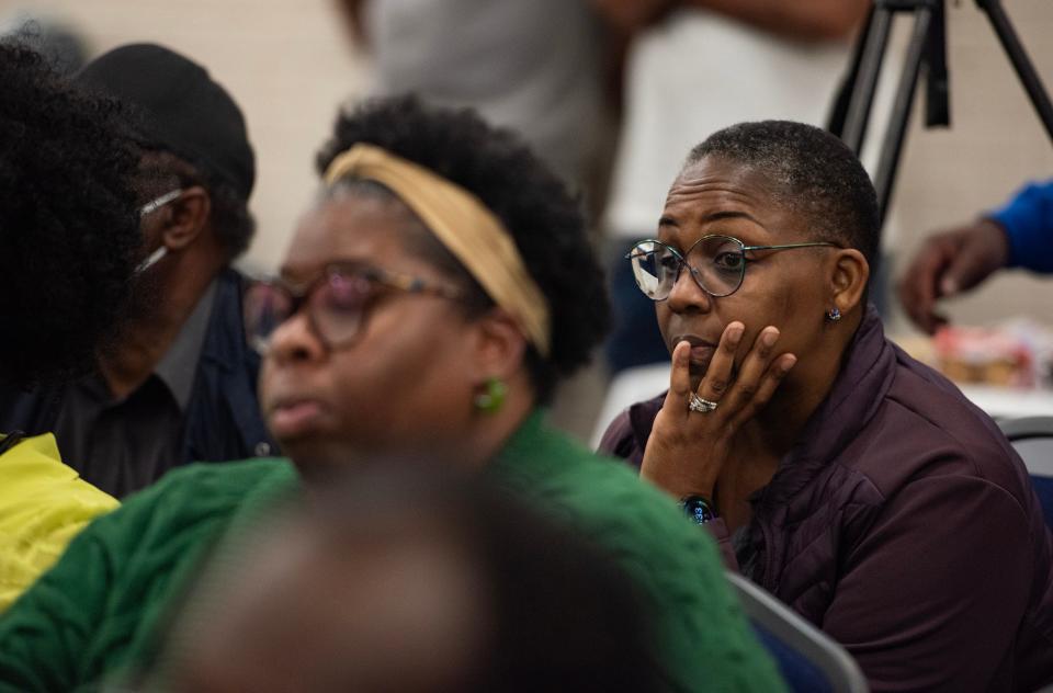 Starkette Stewart holds her head in her hands while listening to someone speak during Ward 3 City Councilman Kenneth Stokes' town hall at Medgar Evers Library in Jackson on Thursday. "There's so much going on in Jackson that we wanted to become more involved," Stewart said of her and her husband, Peter.