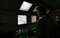 An engineer works in a pilot cabin of a 140-meter-long rock-eating machine dubbed "Federica" in a Turin-Lyon high-speed rail tunnel (TAV) in Saint Martin La Porte, France, Tuesday, Feb. 12, 2019. The project is part of a European wide network to improve high-speed rail connections. On the Italian side, the construction site long targeted by sabotaging protesters is guarded by four law enforcement agencies and has been reduced to maintenance work only. The survival of Italy's increasingly uneasy populist government could very well depend on whether Italy restarts construction on the TAV link, which it halted in June. (AP Photo/Antonio Calanni)