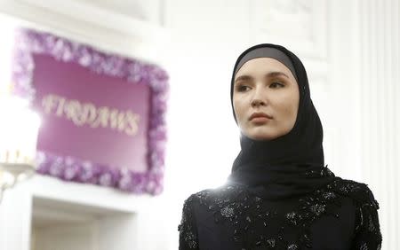 A model presents a creation during a show of the Firdaws fashion house led by Aishat Kadyrova, daughter of the Chechen Republic head Ramzan Kadyrov, at the Mercedes-Benz Fashion Week Russia in Moscow, Russia, March 17, 2017. REUTERS/Sergei Karpukhin