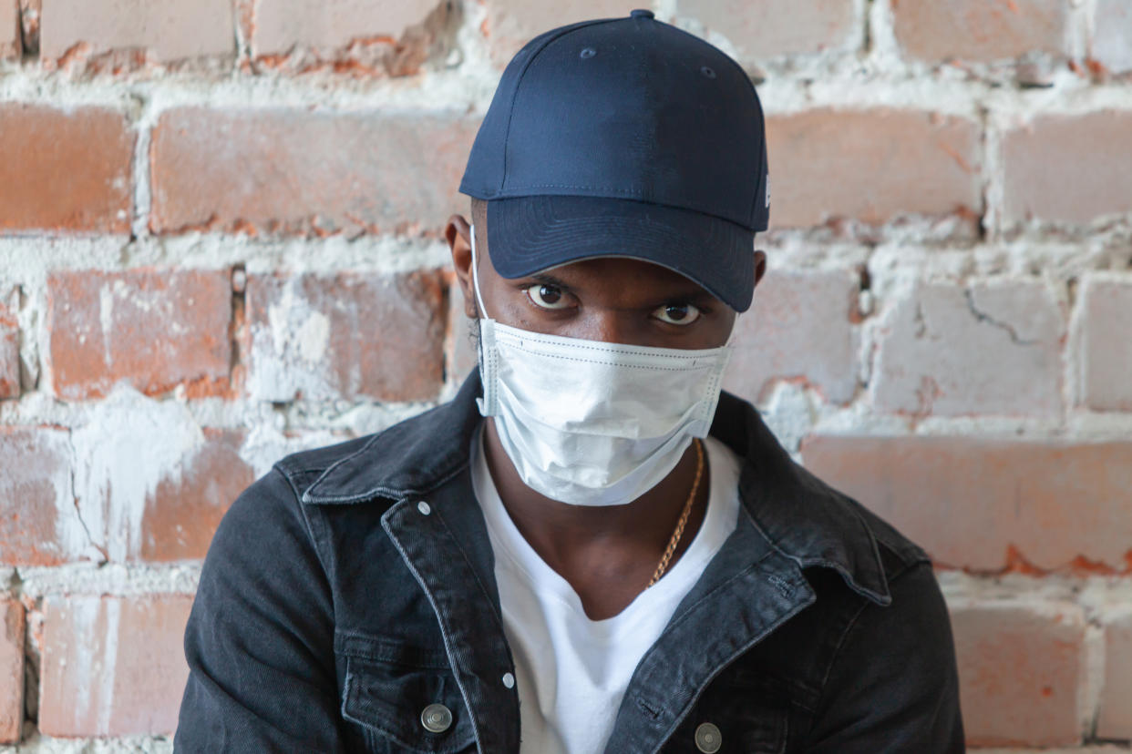 "The criminalization of blackness has spread during this pandemic,” notes one activist, explaining why men of color may fear that wearing masks for protection could bring them more harm than good. (Photo: Getty Images)