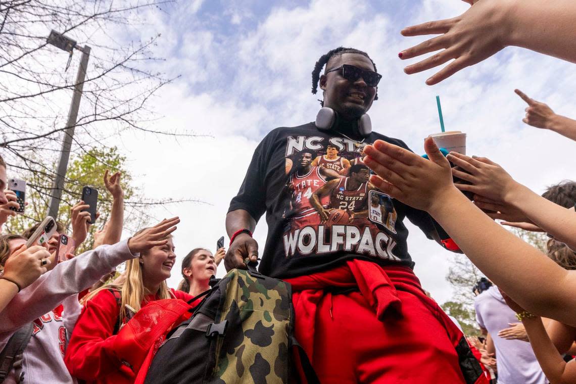 NC.State’s DJ Burns Jr. is greeted by fans as the men’s basketball team departs on a bus Wednesday, April 3, 2024. NC State’s men’s basketball team is headed to the Final Four for the first time since 1983. Travis Long/tlong@newsobserver.com