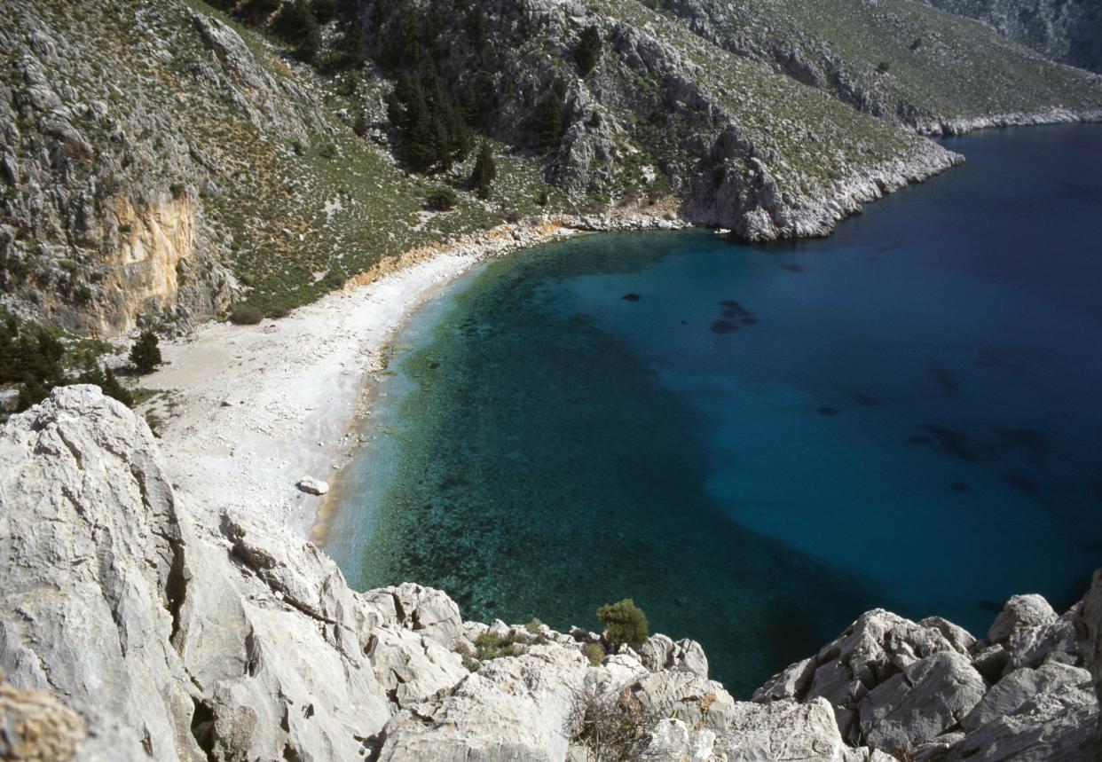 GREECE - JULY 24: A beach along a rocky stretch of coastline, Symi island, Greece. (Photo by DeAgostini/Getty Images)