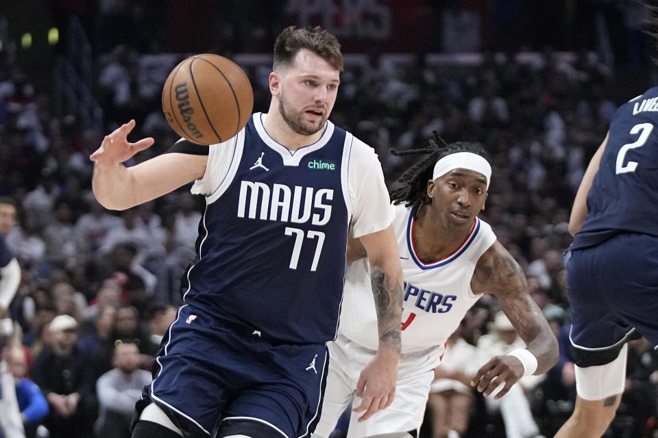 Dallas Mavericks guard Luka Doncic, left, dries toward the basket as Los Angeles Clippers guard Brandon Boston Jr. follows during the second half in Game 5 of an NBA basketball first-round playoff series Wednesday, May 1, 2024, in Los Angeles. (AP Photo/Mark J. Terrill)