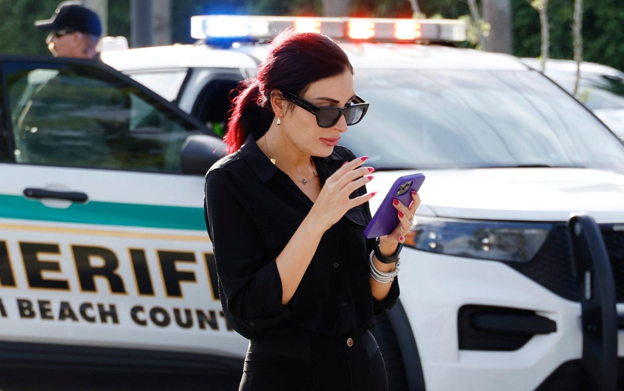 Laura Loomer on her phone in West Palm Beach in the aftermath of the second assassination attempt on Donald Trump's life