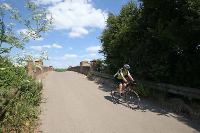 A cyclist crosses the railway bridge in White Waltham, Berkshire (Jonathan Brady/PA)