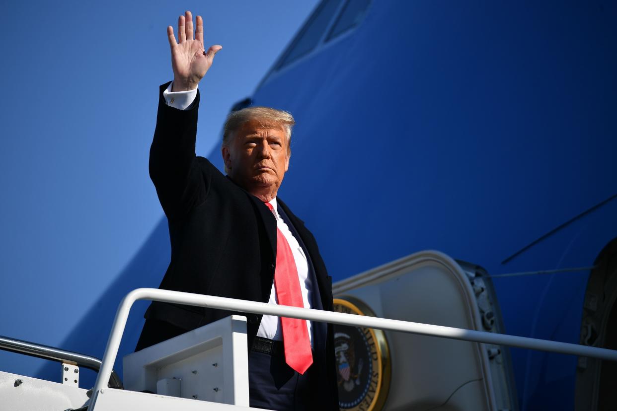 Donald Trump, pictured waving on Jan. 12 before boarding Air Force One, will wave goodbye for good as president before Joe Biden is sworn in, according to reports.  (Photo: MANDEL NGAN via Getty Images)