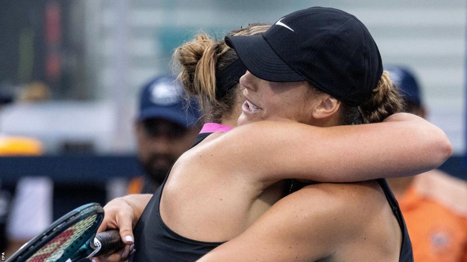 Aryna Sabalenka and Paula Badosa hug at the net