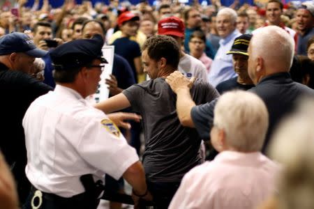 Police remove a protester as Republican presidential nominee Donald Trump holds a rally with supporters in Aston, Pennsylvania, U.S. September 22, 2016. REUTERS/Jonathan Ernst