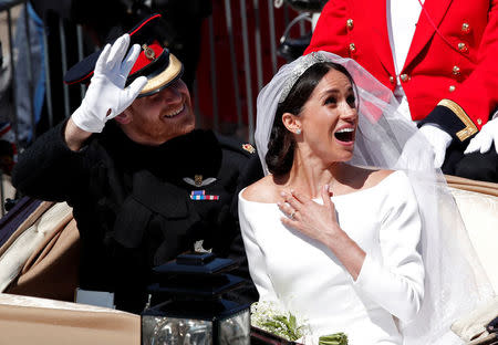 Britain's Prince Harry and his wife Meghan ride a horse-drawn carriage after their wedding ceremony at St George's Chapel in Windsor Castle in Windsor, Britain, May 19. REUTERS/Benoit Tessier