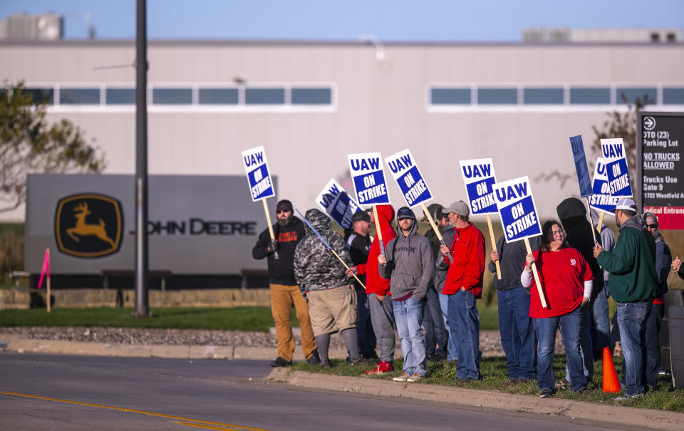 John Deere Drivetrain Operations workers in Waterloo, Iowa, stand on the picket line at the plant as the UAW officially started its strike on Thursday, Oct. 14, 2021. More than 10,000 Deere & Co. workers went on strike Thursday after the United Auto Workers union said negotiators couldn't deliver a new agreement that would meet the “demands and needs” of workers. (Chris Zoeller/The Courier via AP)