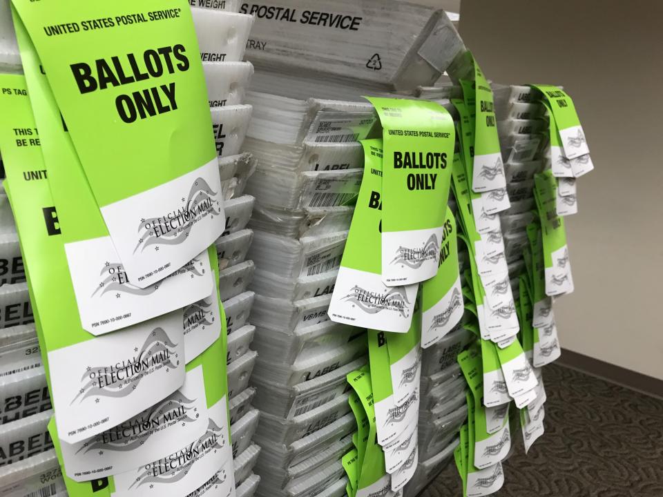 Stacks of postal bins await absentee ballots to be mailed.