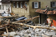 <p>A man in Braunsbach, in Baden-Wuerttemberg, Germany, looks at damage on May 30, 2016, that was caused by flooding. (Kai Pfaffenbach/Reuters) </p>