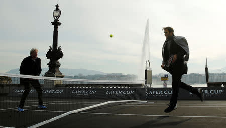 Switzerland's Roger Federer returns the ball to Bjorn Borg of Sweden (L) during a tennis session to promote the Laver Cup tennis tournament on a temporary court on the banks of Lake Geneva in Geneva, Switzerland February 8, 2019. REUTERS/Arnd Wiegmann