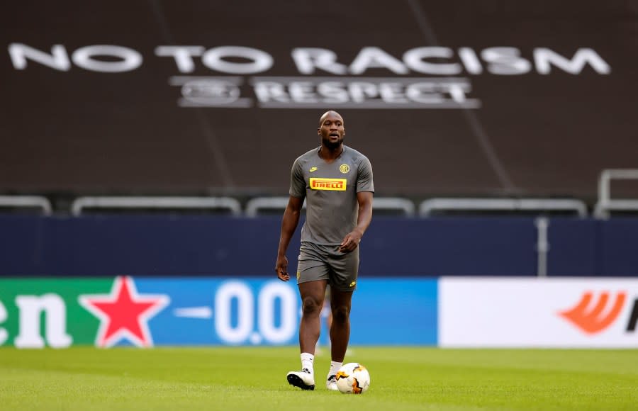 Inter Milan’s Romelu Lukaku walks on the pitch in front of a ‘no to racism’ banner during the training session prior the Europa League round of 16 soccer match between Inter Milan and Getafe at the Veltins-Arena in Gelsenkirchen, Germany, Tuesday, Aug. 4, 2020. (Lars Baron/Pool via AP)