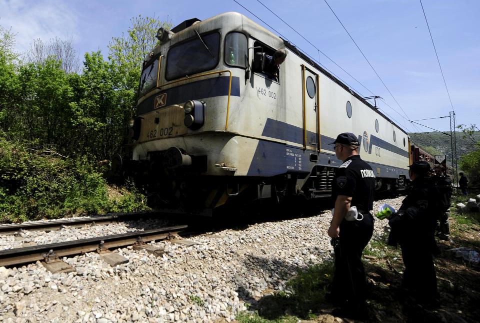 Media and police inspect at the scene where fourteen migrants were hit by a train, near Veles, April 24, 2015. Fourteen migrants were hit by a train and killed in central Macedonia late on Thursday as they walked through a canyon along an increasingly well-trodden Balkan route for migrants trying to reach western Europe. The accident happened at around 10.30 p.m. (2030 GMT) near the central city of Veles. Rescue efforts were hampered by difficult terrain, with the site of the accident accessible only by foot or railway. REUTERS/Ognen Teofilovski