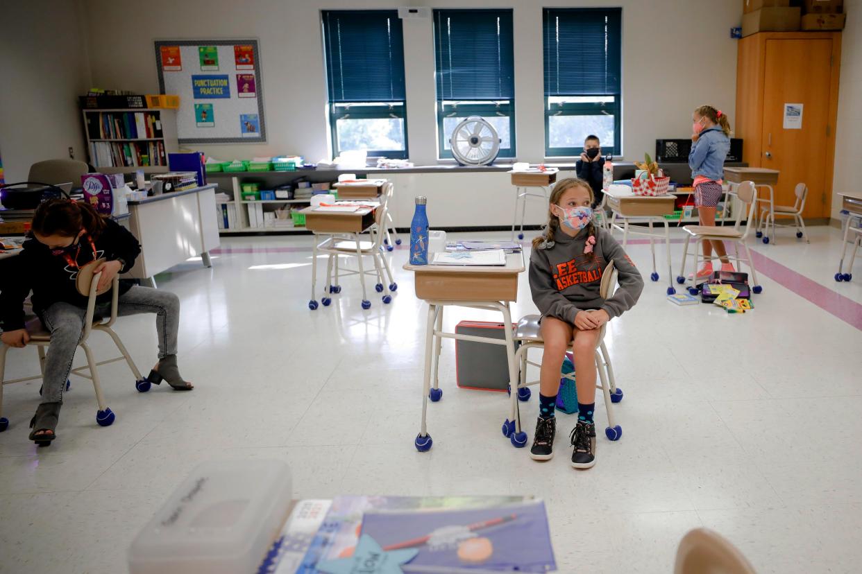 Children socially distance at school (AP)