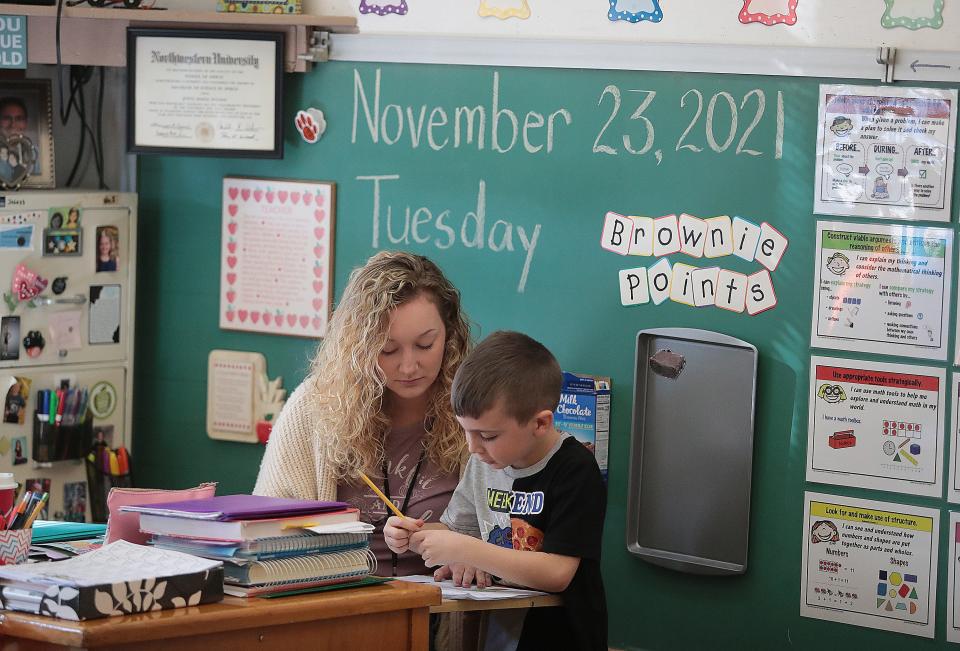 Whittier Elementary student teacher Hannah Boerner works with first grader Oliver Crousser on a writing assignment. The district plans to build two new pre-kindergarten to third grade schools to replace the district's three aging elementary schools.