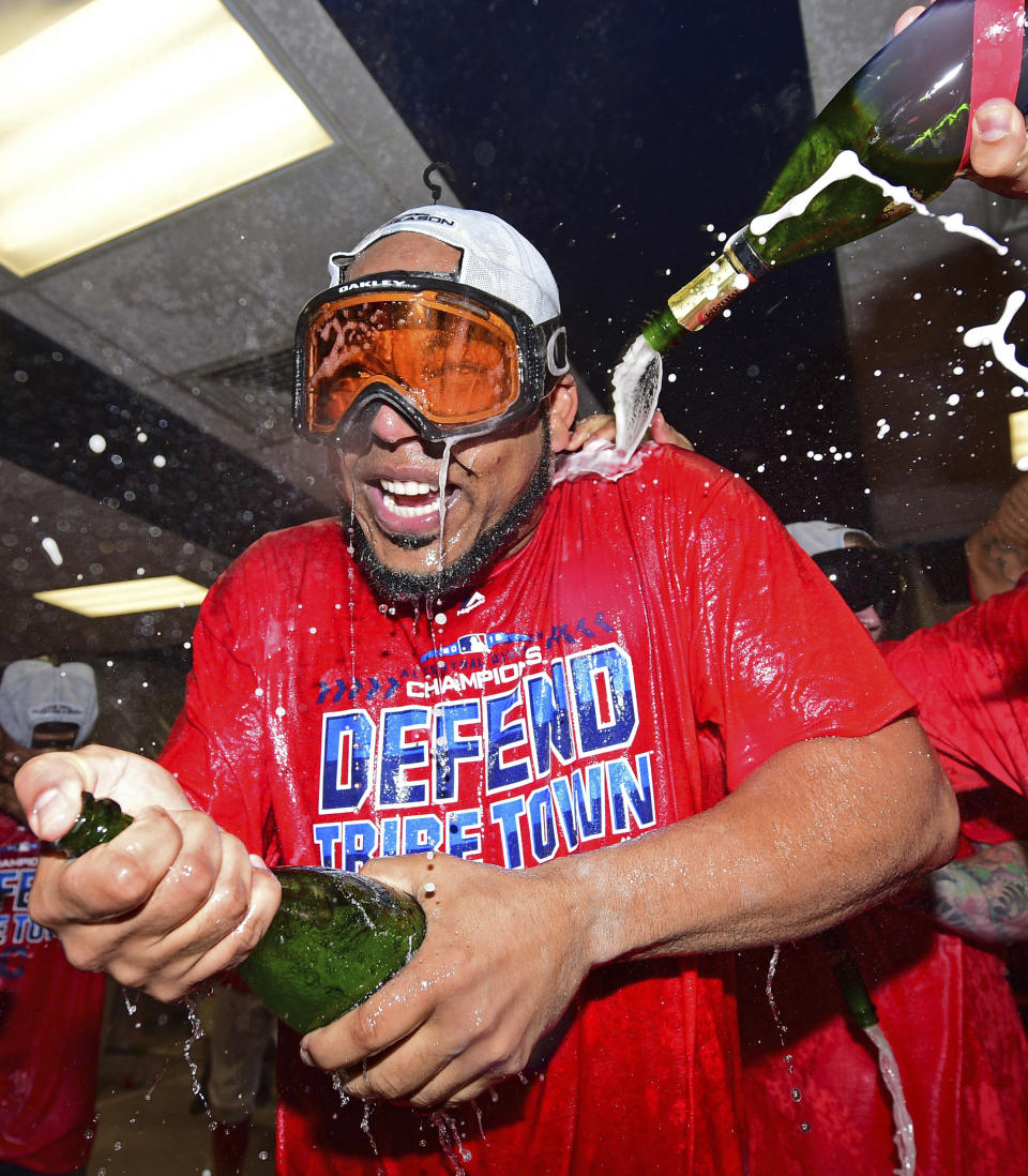 Cleveland Indians' Edwin Encarnacion celebrates in the clubhouse after the Indians defeated the Detroit Tigers 15-0 to clinch the American League Central Division, in a baseball game, Saturday, Sept.15, 2018, in Cleveland. (AP Photo/David Dermer)