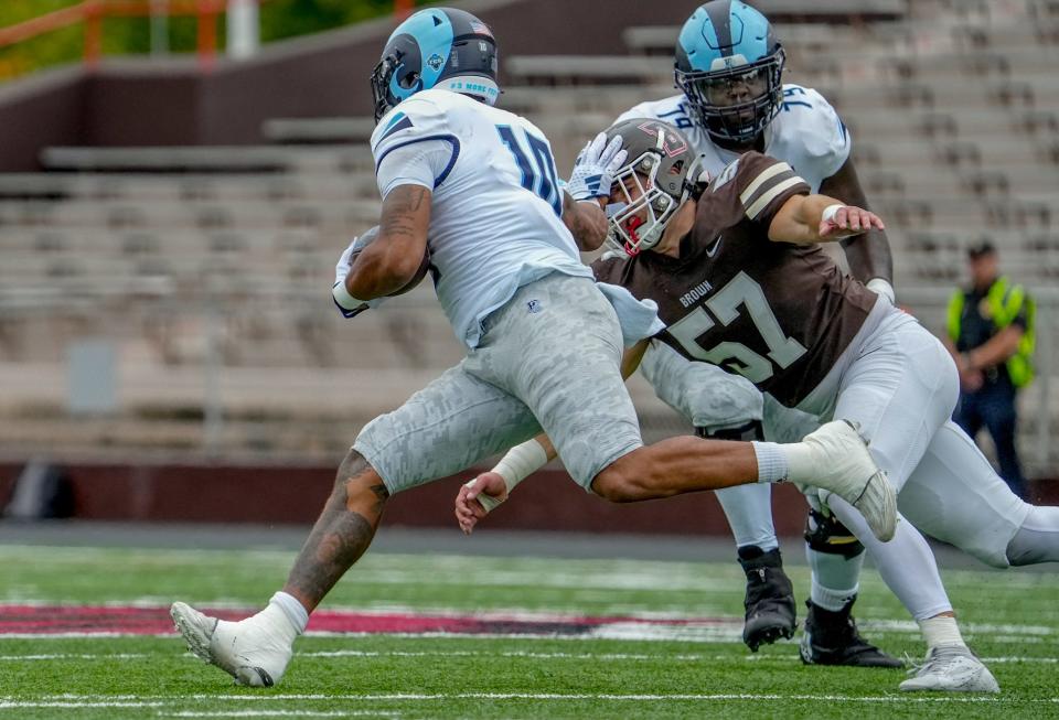 Rhode Island's Ja'Den McKenzie grinds out yardage in the fourth quarter of Saturday's Governor's Cup game against Brown.