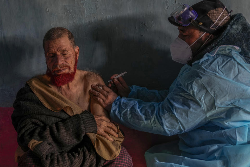 Masrat Farid, a healthcare worker, administers a dose of Covishield vaccine to Ghulam Yousaf Mir during a COVID-19 vaccination drive in Gagangeer, northeast of Srinagar, Indian controlled Kashmir, Jan. 12, 2022. (AP Photo/Dar Yasin)