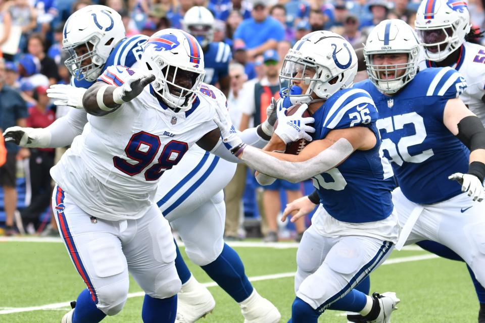 Indianapolis Colts running back Evan Hull runs the ball against Buffalo Bills defensive tackle Poona Ford in the second quarter of a preseason game at Highmark Stadium.