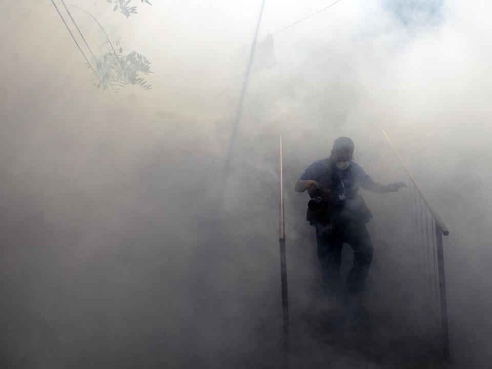 Health ministry employees fumigate against the Aedes aegypti mosquito to prevent the spread of the Zika virus in El Salvador in 2016 (Getty)