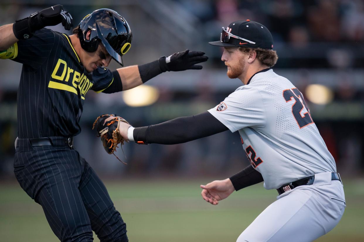 Oregon State infielder Jacob Krieg tags out Oregon catcher Anson Aroz as he runs to first as the Oregon Ducks host the Oregon State Beavers April 30 at PK Park in Eugene.