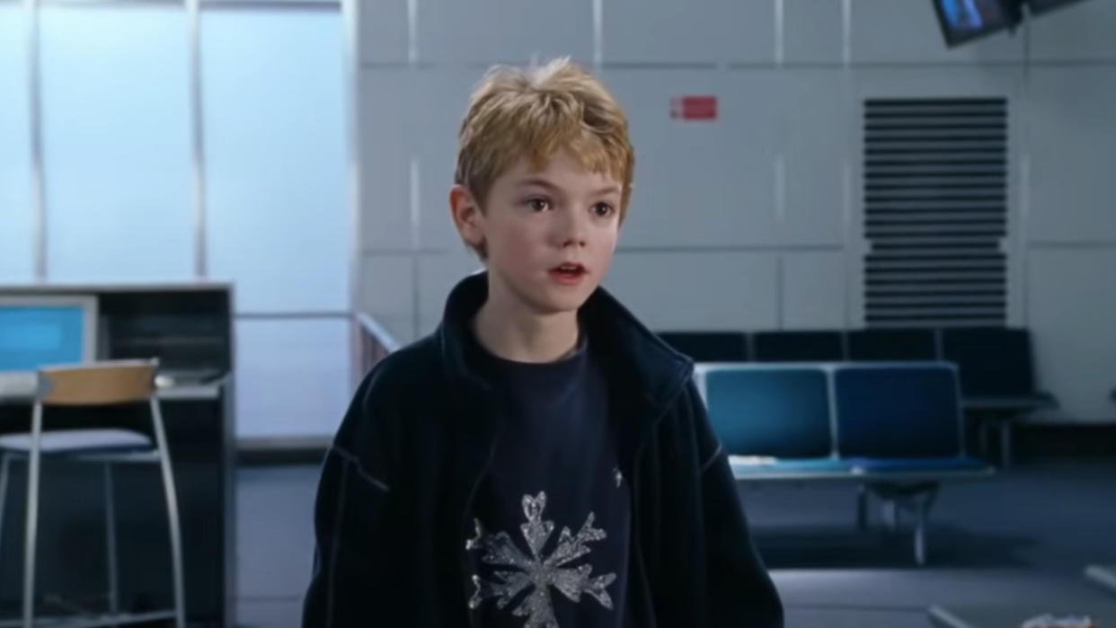  Thomas Brodie-Sangster standing in an airport lounge in Love, Actually. 